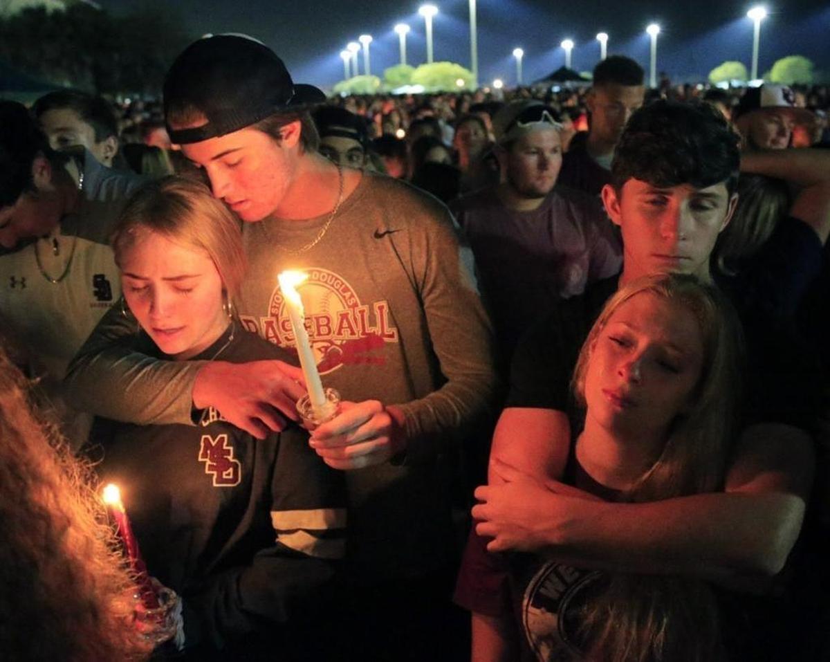 On Thursday, Feb. 15, 2018, students hold a candlelight vigil at Pines Trails Park & Amphitheater in honor of shooting victims from Marjory Stoneman Douglas High School.
