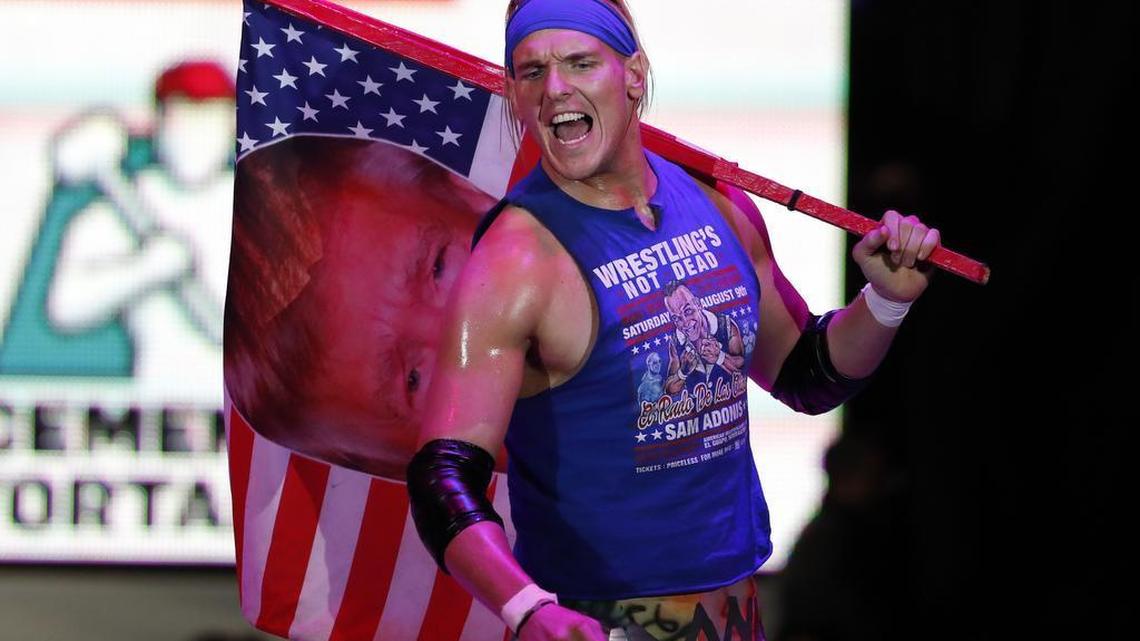 American pro wrestler Sam Polinsky aka Sam Adonis holds an American flag emblazoned with a photo of U.S. President Donald Trump, as he arrives in Arena Mexico, in Mexico City, Sunday, Feb. 12, 2017. A self-described pro-wrestling purist who grew up in Pittsburgh, Pennsylvania and came to Mexico last year, Polinsky says taking on the persona of a Trump supporter was an unparalleled chance to play the ultimate villain.