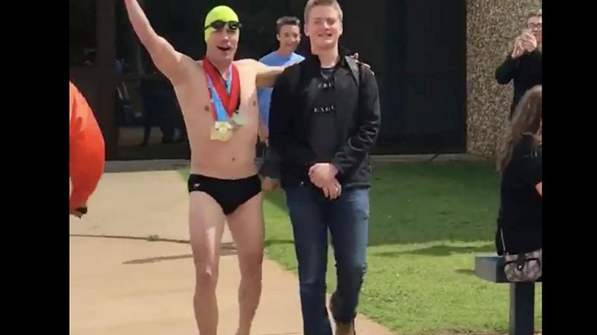 Justin Beadles picked up his 15-year-old son on the last day of school dressed like Olympic swimmer Michael Phelps.