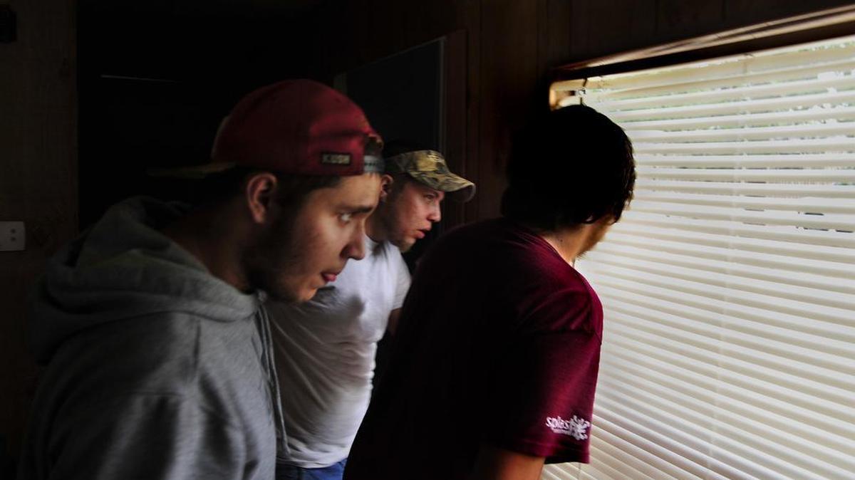 
The Meek brothers – Jacob, Joey and Justin, from left – are very nervous as the FBI knocks on their door in Red Bank, S.C., which they call “Dead Bank.” Joey is in a near panic as he thinks they have come for him. There’s a constant air of tension in the home, and the slightest noise outside provokes a peek out the window. 

