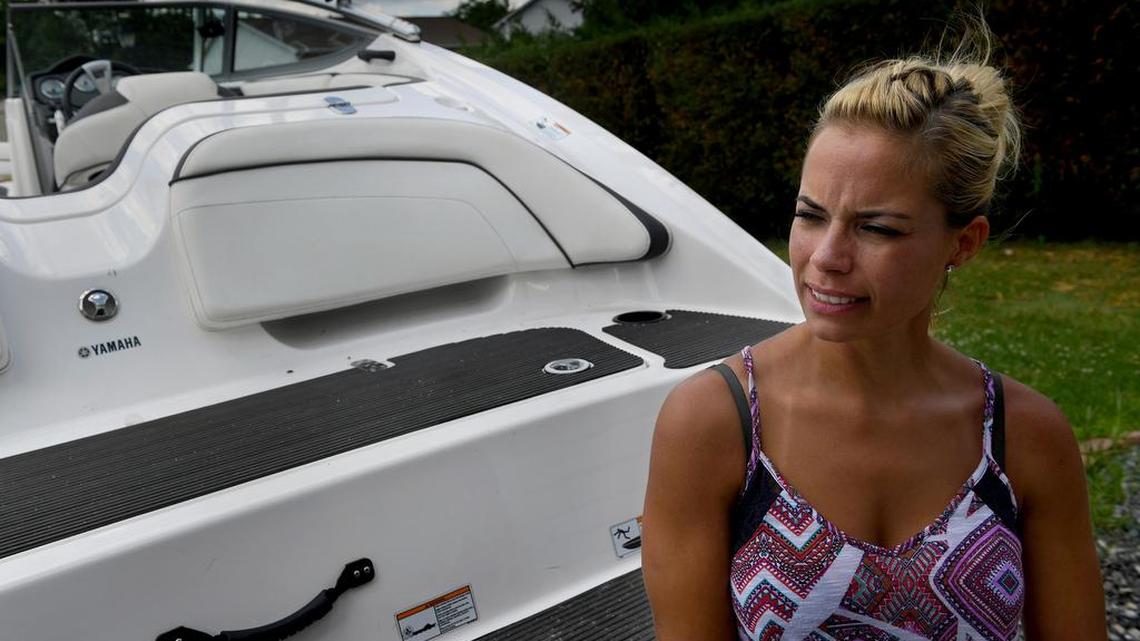 Lauren Conner stands beside the boat from which she fell. Concern about her children and her familiarity with water helped her survive. Must credit: Washington Post photo by Michael S. Williamson
