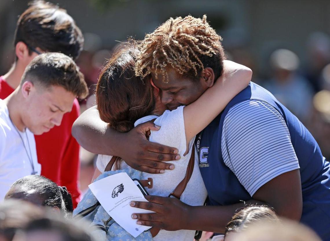 Attendees comfort each other at community prayer vigil at Parkridge Church for shooting victims from Marjory Stoneman Douglas High School