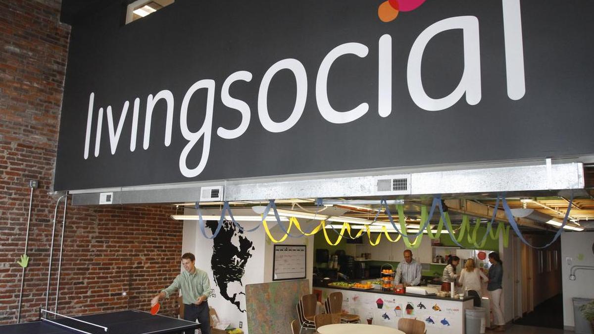 In this photo, Ross Arbes, 24, left, plays ping pong while on break at LivingSocial’s offices in Washington, D.C., on April 29, 2011. LivingSocial is being sold to Groupon.