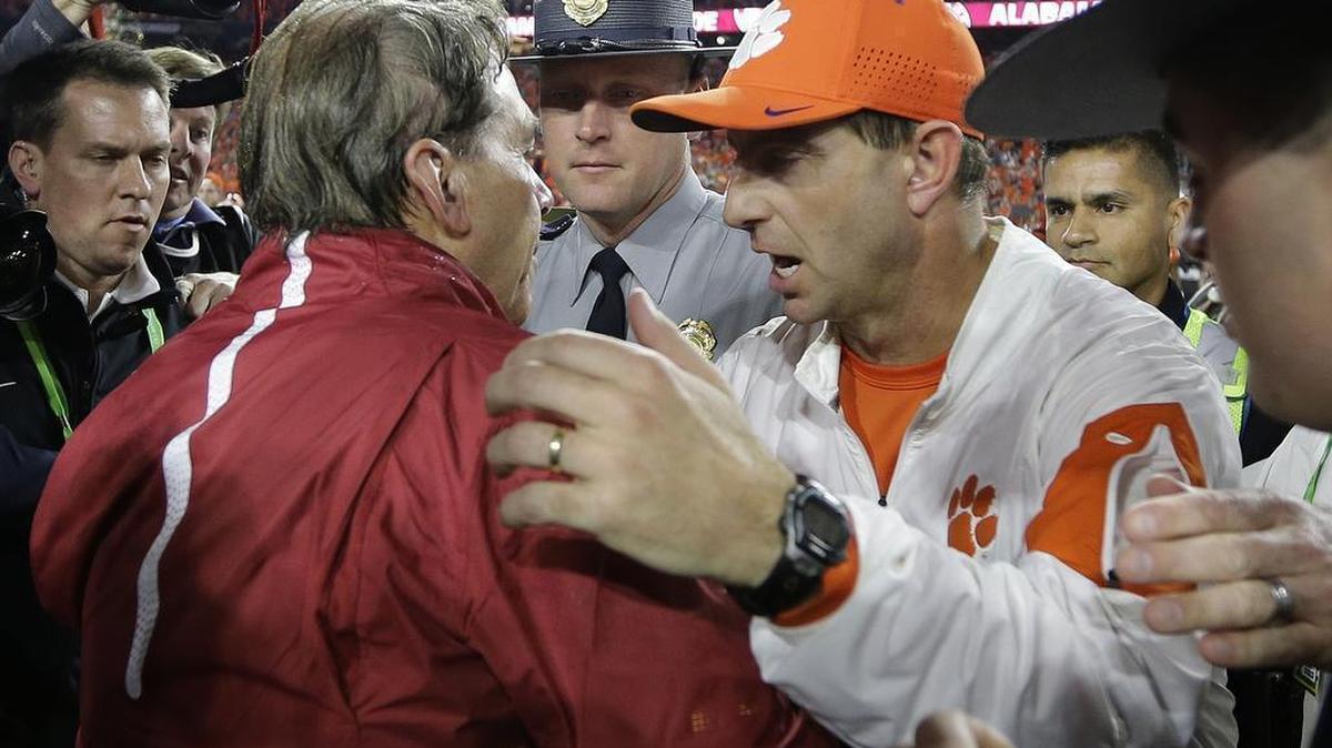 Alabama head coach Nick Saban, left, talks to Clemson head coach Dabo Swinney after the NCAA college football playoff championship game Monday in Glendale, Ariz. Alabama won 45-40.