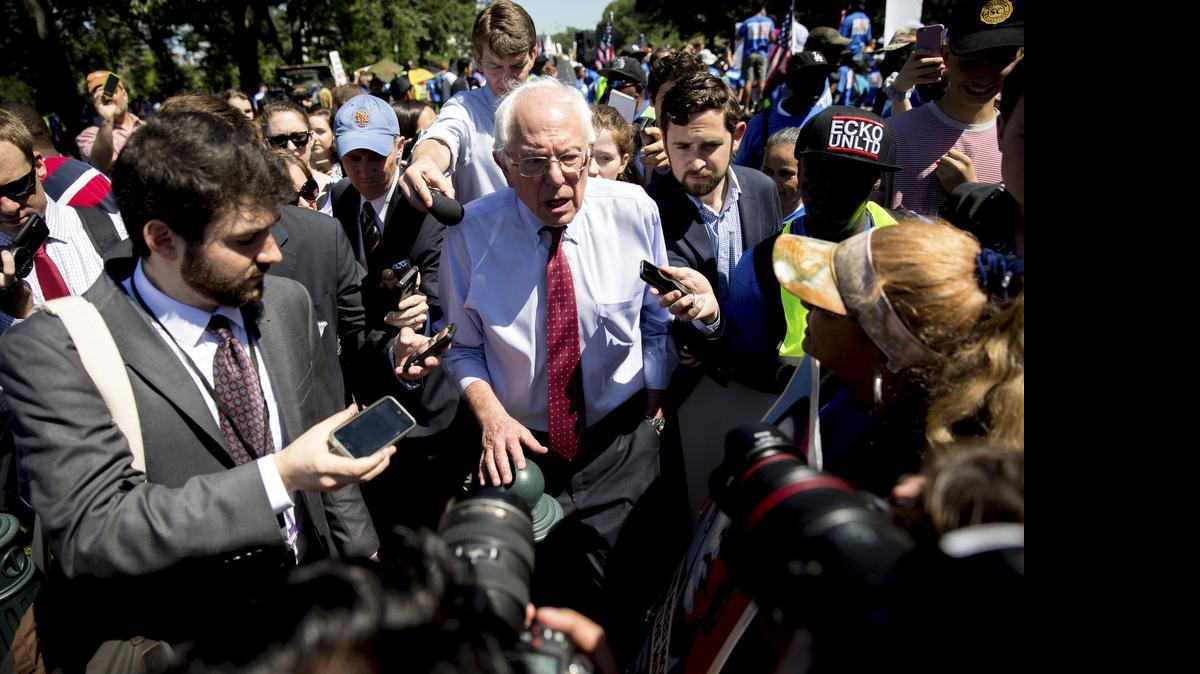 
Democratic presidential candidate Sen. Bernie Sanders, I-Vt., speaks to reporters after speaking to federal contract workers at a rally on Capitol Hill in Washington, Wednesday, July 22, 2015, to push for a raise to the minimum wage to $15 an hour.

