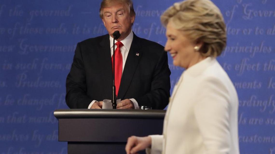 Republican presidential nominee Donald Trump waits behind his podium as Democratic presidential nominee Hillary Clinton makes her way off the stage following the third presidential debate Oct. 19 at UNLV in Las Vegas.
