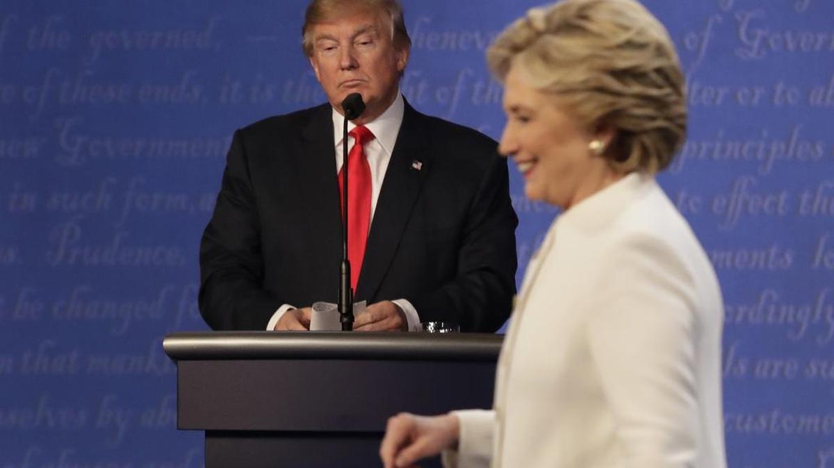 Republican presidential nominee Donald Trump waits behind his podium as Democratic presidential nominee Hillary Clinton makes her way off the stage following the third presidential debate Oct. 19 at UNLV in Las Vegas.