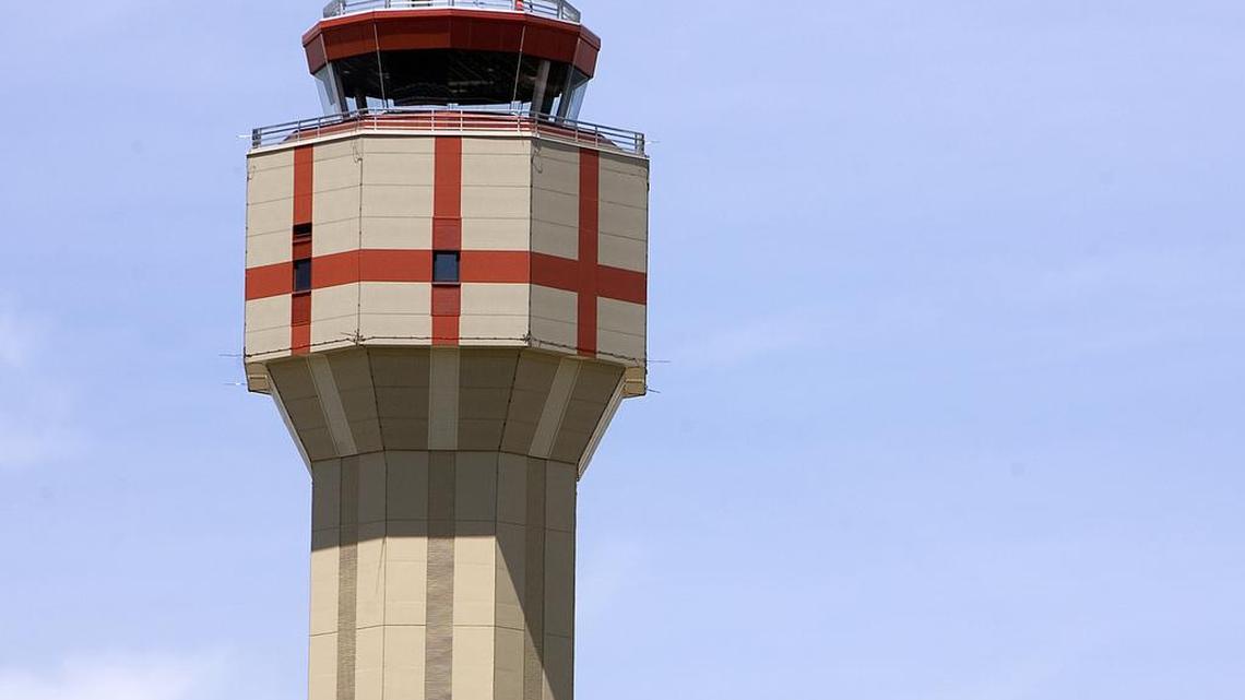 Air traffic controllers monitor planes from inside the Boise Airport tower.