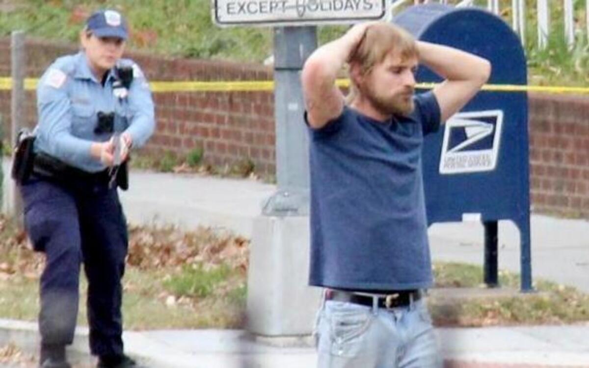 FILE- In this Dec. 4, 2016, file photo, Edgar Maddison Welch, 28 of Salisbury, N.C., surrenders to police in Washington. Welch, who fired an assault riffle multiple times inside a pizza restaurant in the nation's capital while investigating an internet conspiracy theory is expected in court Tuesday, Dec. 13, for a hearing on whether he should stay in jail while he awaits trial.