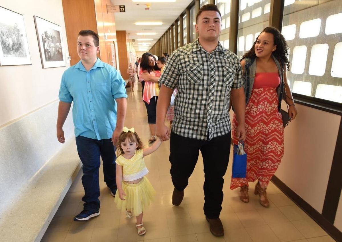 Carson Petersen heads into his adoption hearing with sister Kaylynn Petersen, 4, brother Hunter Petersen, left, and girlfriend Lauren Raley, right.