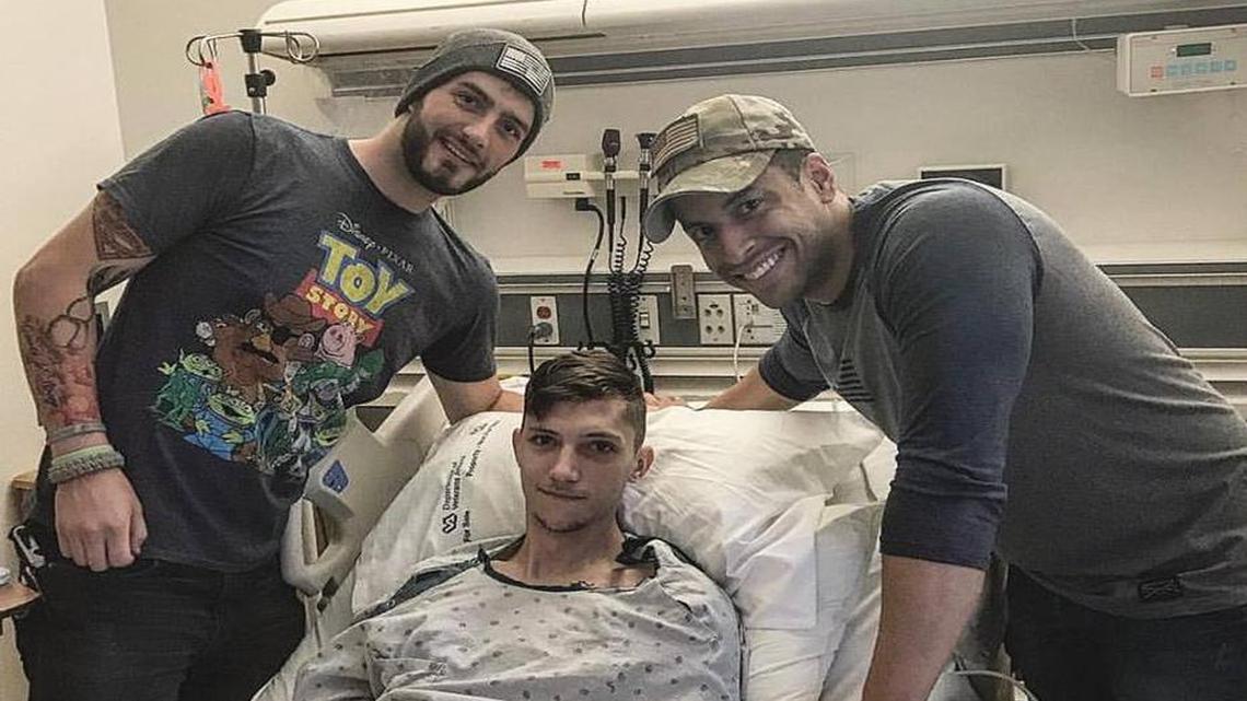 Drew Strong (left) and Drew Hernandez (right) pose with Jake Mitchell (center), an Air Force veteran who suffered from a collapsed lung.