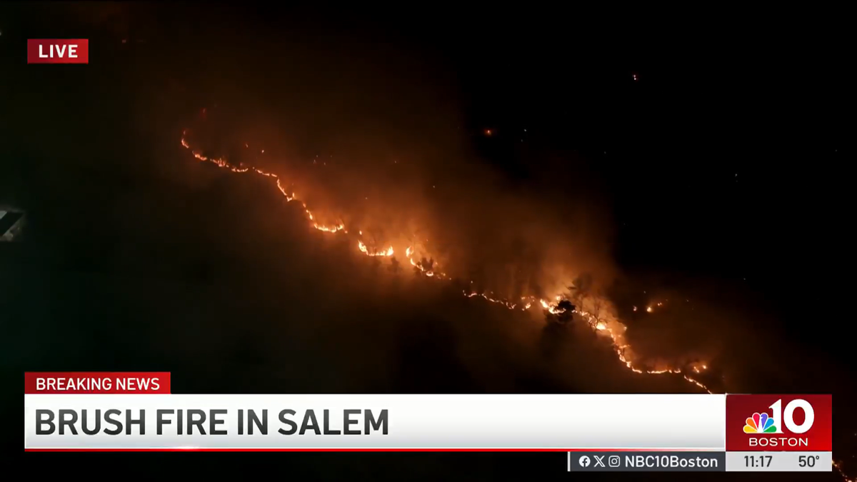 A brush fire is burning through acres in parts of Salem and Lynn, Massachusetts.