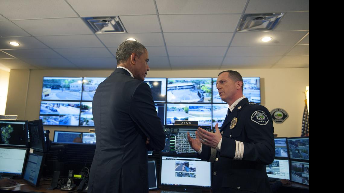 
President Barack Obama tours the Real-Time Tactical Operational Intelligence Center in the Camden County Police Administration Building with Camden County Police Chief J. Scott Thomson on Monday, May 18, 2015, in Camden, N.J. 
