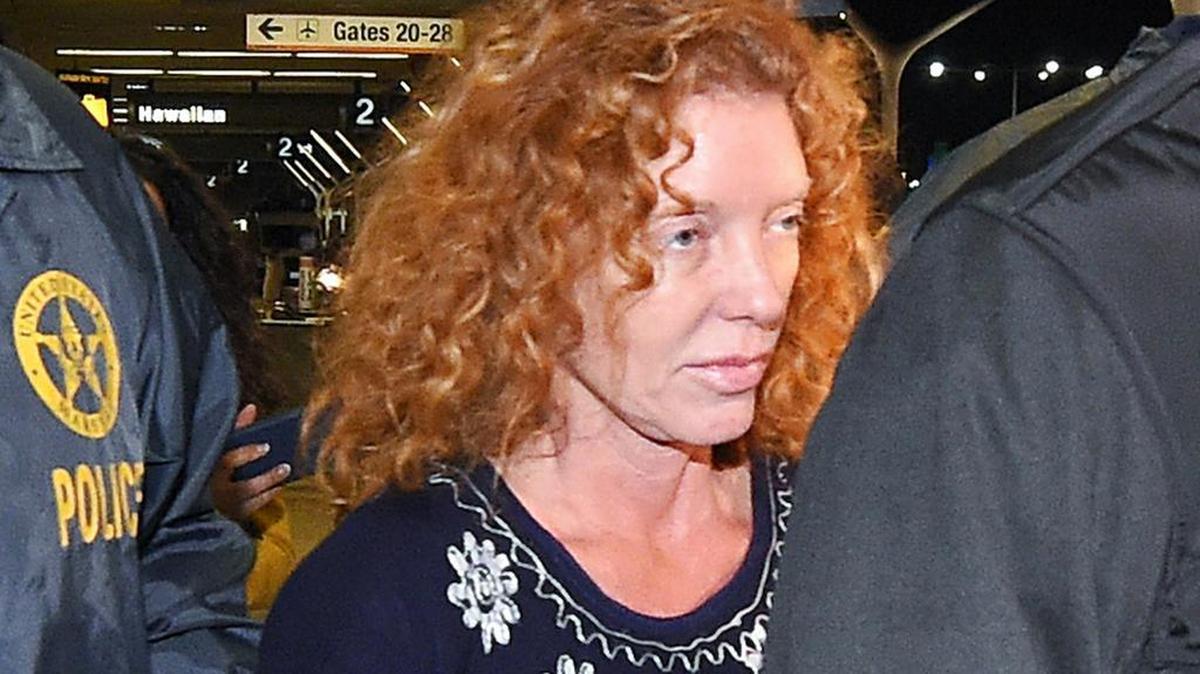 Tonya Couch, center, is taken by authorities to a waiting car after arriving at Los Angeles International Airport, Thursday, Dec. 31, 2015, in Los Angeles. Authorities said she and her son, Texas teenager Ethan Couch, who was sentenced to probation after using an “affluenza” defense for a 2013 fatal wreck in Texas, fled to Mexico together in November as prosecutors investigated whether he had violated his probation. Both were taken into custody Monday, Dec. 28, after authorities said a phone call for pizza led to their capture in the resort city of Puerto Vallarta.