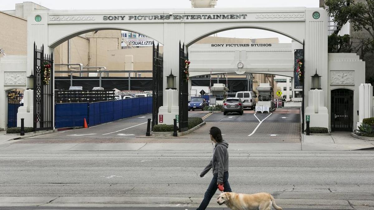 
A local resident walks her dog by the gates of Sony Pictures Entertainment Studios on Overland Avenue in Culver City, Calif. 
