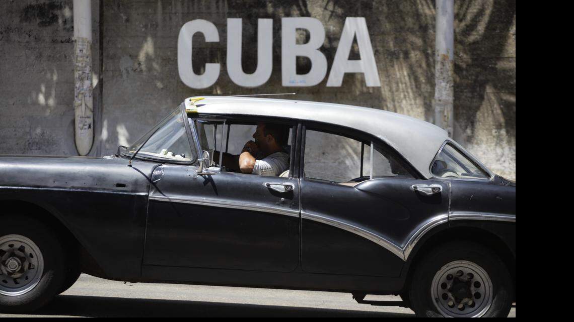 
A man drives his taxi past a Cultural Center on April 14, 2015, in Havana, Cuba. An agricultural bill introduced April 22, 2015, is the latest in a series of legislative and administrative steps taken since President Barack Obama in December announced a thawing of relations with the island nation. 
