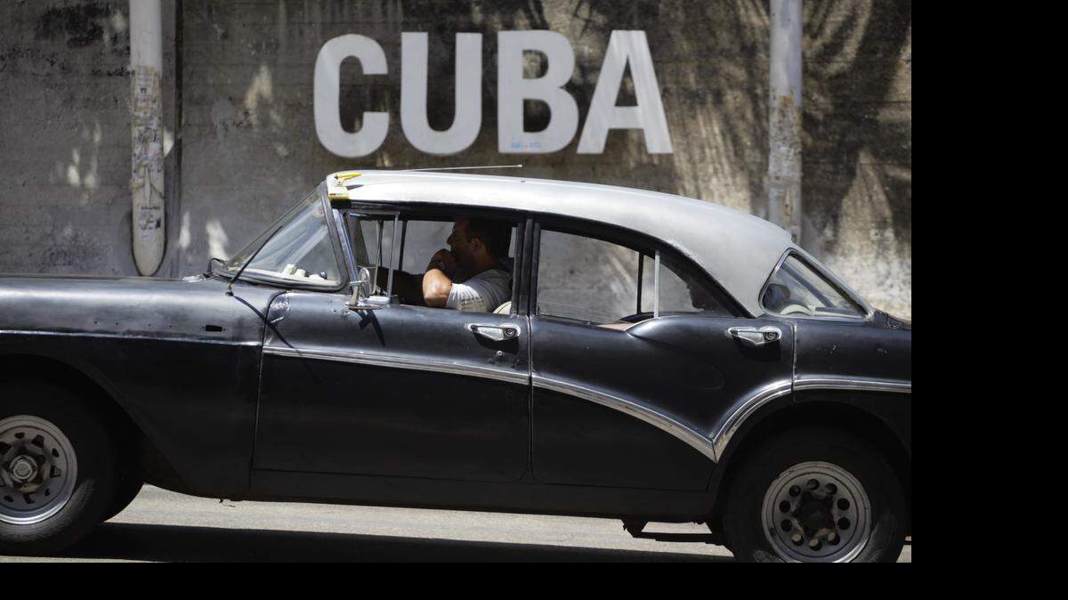 
A man drives his taxi past a Cultural Center on April 14, 2015, in Havana, Cuba. An agricultural bill introduced April 22, 2015, is the latest in a series of legislative and administrative steps taken since President Barack Obama in December announced a thawing of relations with the island nation. 
