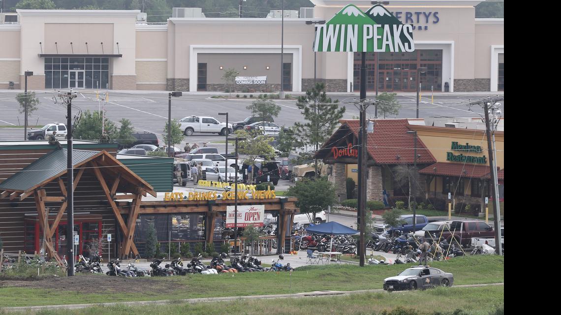 
Law enforcement investigate the motorcycle gang related shooting at the Twin Peaks restaurant, Monday, May 18, 2015, in Waco, Texas, where 9 were killed Sunday and over a dozen injured. Waco police on Monday announced the Texas Alcoholic Beverage Commission closed Twin Peaks for a week amid safety concerns. 
