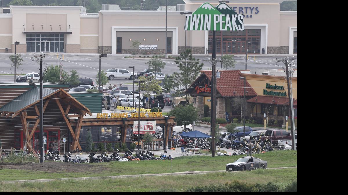 
Law enforcement investigate the motorcycle gang related shooting at the Twin Peaks restaurant, Monday, May 18, 2015, in Waco, Texas, where 9 were killed Sunday and over a dozen injured. Waco police on Monday announced the Texas Alcoholic Beverage Commission closed Twin Peaks for a week amid safety concerns. 
