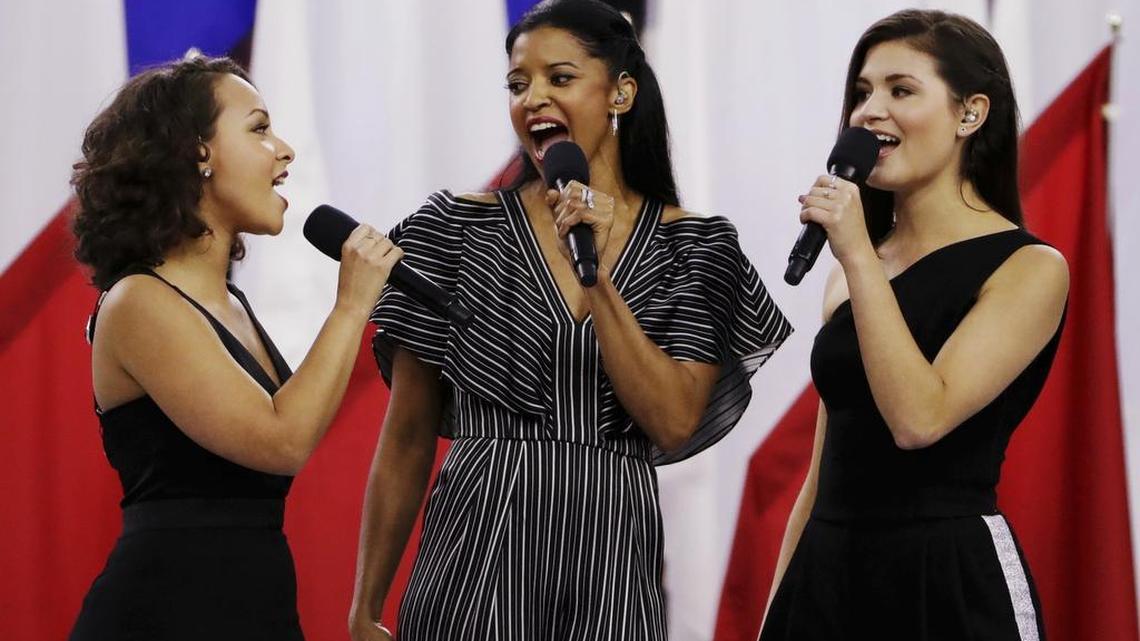 Singers of the cast of Hamilton, Phillipa Soo, right, Rene Elise Goldsberry, center, and Jasmine Cephas Jones, sing "God Bless America," before the NFL Super Bowl 51 football game between the New England Patriots and the Atlanta Falcons, Sunday, Feb. 5, 2017, in Houston.