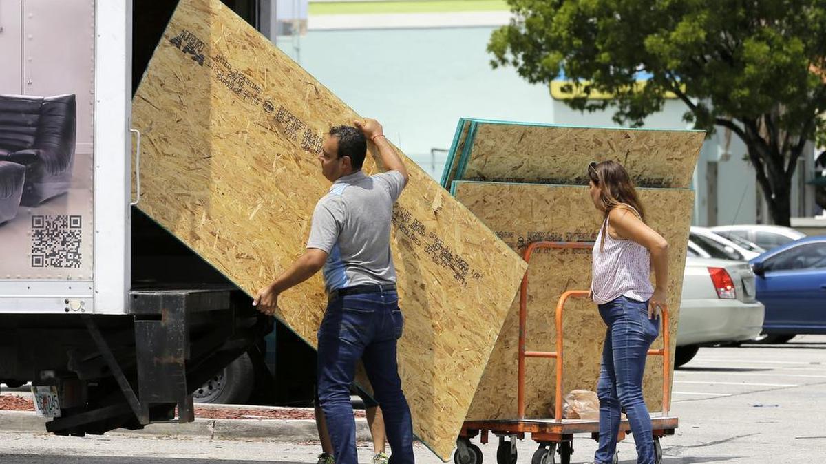 Residents load sheets of strand board on a truck as they prepare for Hurricane Irma on Tuesday in Hialeah, Fla. Hurricane Irma grew into a dangerous Category 5 storm, the most powerful seen in the Atlantic in over a decade, and roared toward islands in the northeast Caribbean Tuesday on a path that could eventually take it to the United States.