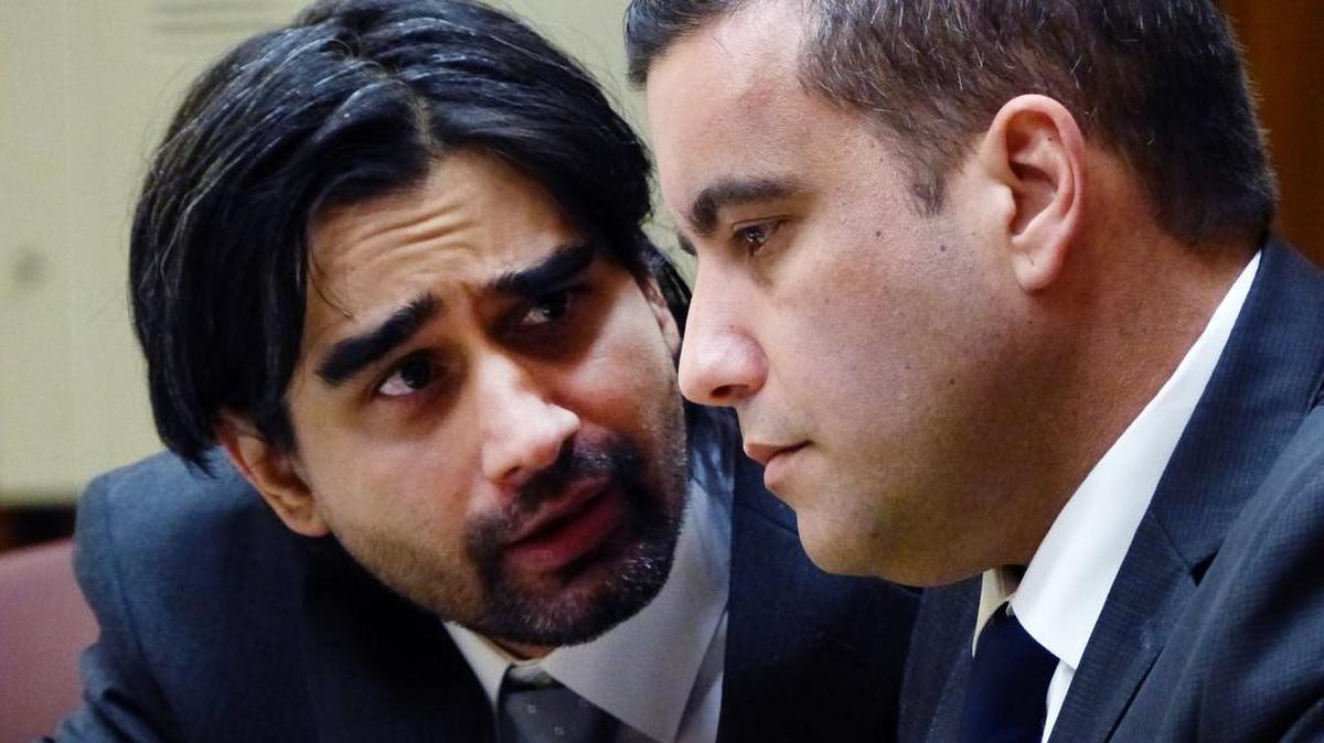 Derek Medina, left, who was convicted Wednesday, Nov. 25, 2015, of killing his wife and posting a picture of her dead body on Facebook, talks with his lawyer, Mauricio Padilla, during the third day of his trial on Nov. 13, 2015, at the Miami Dade criminal court in Miami.