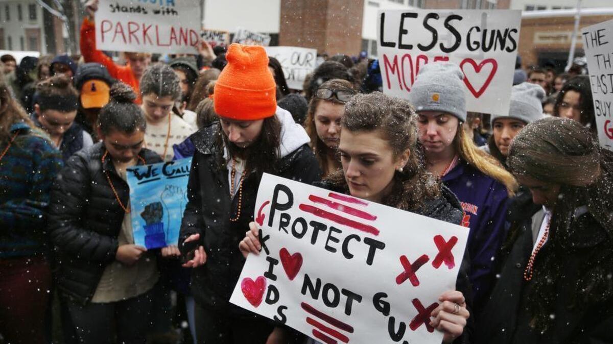 Students at Yarmouth High School observe a moments of silence in honor of those killed in the Parkland, Fla., school shooting during a walkout to protest gun violence, Wednesday in Yarmouth, Maine.