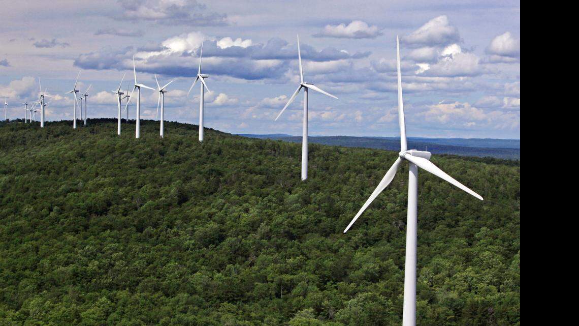 
 Wind turbines line a ridge on Stetson Mountain in Stetson, Maine, on July 14, 2009. Far more jobs have been created in wind and solar in recent years than lost in the collapse of the coal industry, researchers say. 
