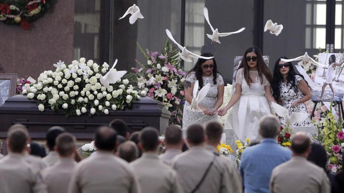 Yvette Velasco’s sisters release doves during her funeral Thursday. Velasco was one of the 14 people killed in the San Bernardino shootings.