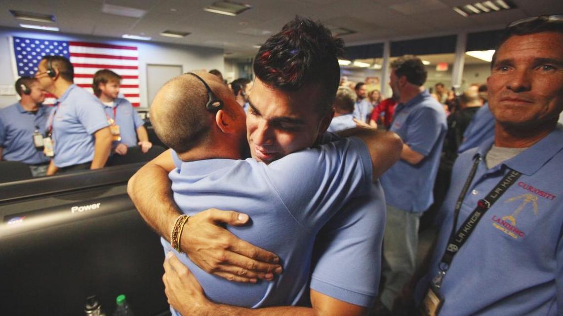 In this file photo taken Sunday Aug. 5, 2012, Bobak Ferdowsi, the activity lead for NASA's Curiosity mission to Mars, who cuts his hair differently for each mission, works inside the Spaceflight Operations Facility for NASA's Mars Science Laboratory, MSL, at Jet Propulsion Laboratory in Pasadena, Calif.