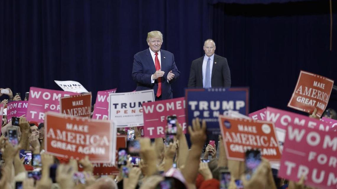 Republican presidential candidate Donald Trump, center, takes the stage at a campaign rally Saturday, Oct. 29, 2016, in Phoenix.