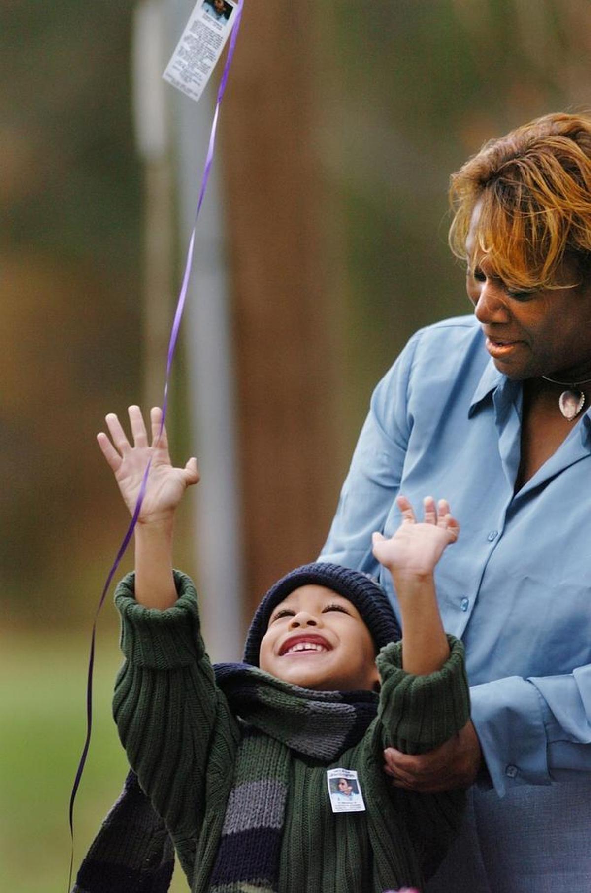 Just before his fifth birthday, Saundra Adams (right) brought her grandson Chancellor Lee to his mother’s gravesite in Charlotte. They released five balloons in honor of his fifth birthday and in memory of his mother, Cherica Adams, who was murdered in 1999 in a conspiracy masterminded by former Carolina Panther Rae Carruth.
