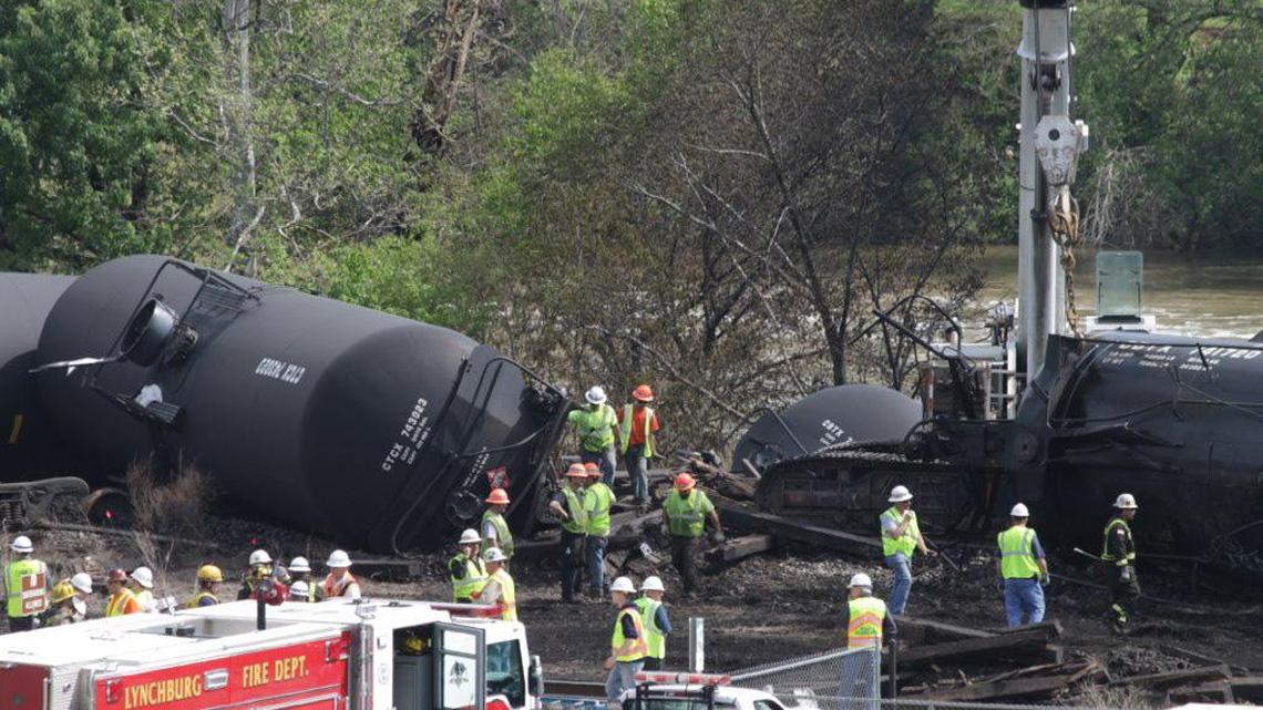 
Contract workers begin cleaning up the site of an oil train derailment in Lynchburg, Va., on May 1, 2014.
