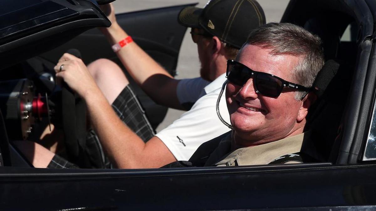 Indy Racing League driver Sam Schmidt smiles after blowing out a tire while performing a burnout with his modified Corvette on Tuesday, Sept. 27, 2016, in Las Vegas. Schmidt, paralyzed from the neck down in a crash 16 years ago, is set to receive the first autonomous vehicle driver’s license in the U.S. Disability advocates hope it’s a prelude to a future where autonomous cars are widely accessible to the disabled.