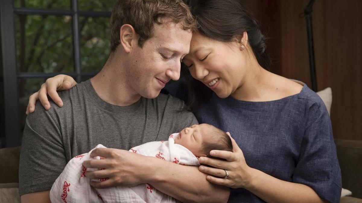 In this undated photo provided by Mark Zuckerberg, Max Chan Zuckerberg is held by her parents, Mark Zuckerberg and Priscilla Chan Zuckerberg. Facebook CEO Mark Zuckerberg and his wife announced the birth of their daughter, Max, as well as plans to donate most of their wealth to a new organization that will tackle a broad range of the world's ills.