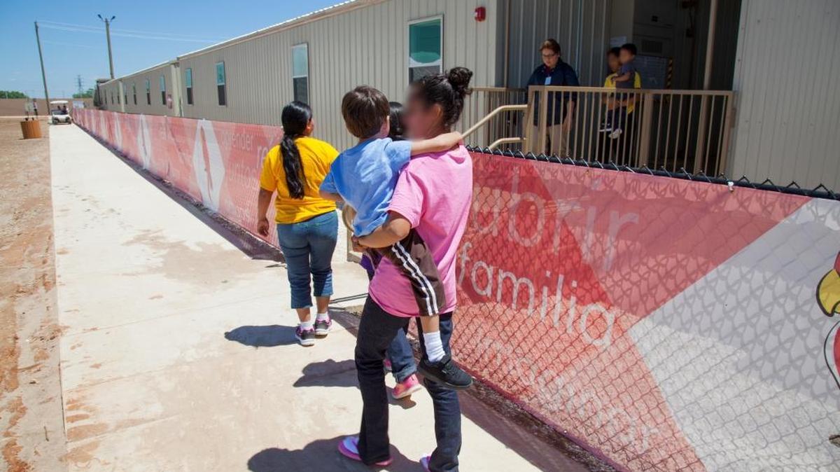 A mother and child walk in the common campus area at the Dilley, Texas, family detention center. Federal officials have until Friday to comply with a judge’s order to end long-term family detention.