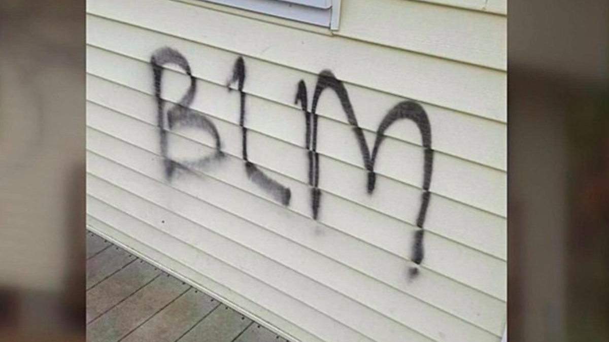 The letters spray-painted onto Maria Daly’s house, an apparent reference to the Black Lives Matter cause. Daly later admitted to spray-painting the letters herself.