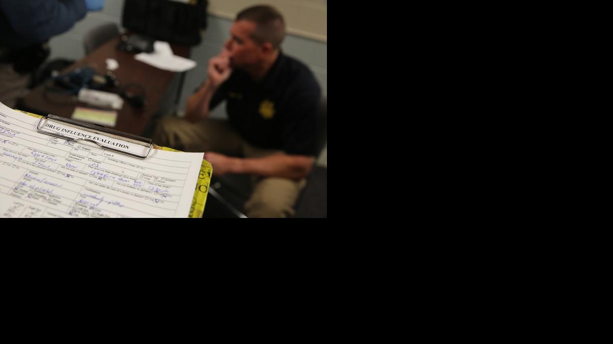 
In this March 6, 2014 file photo, an instructor for a Drug Recognition Expert class, sits near a completed roadside Drug Influence Evaluation sheet on a clipboard, at the Colorado State Patrol Training Academy, in Golden, Colo. Legalizing marijuana reduces drug arrests but doesn't solve one of the central goals of drug-policy reformers, ending racial disparities in marijuana enforcement. That's according to a new review of Colorado's criminal justice system before and after pot was made legal. 
