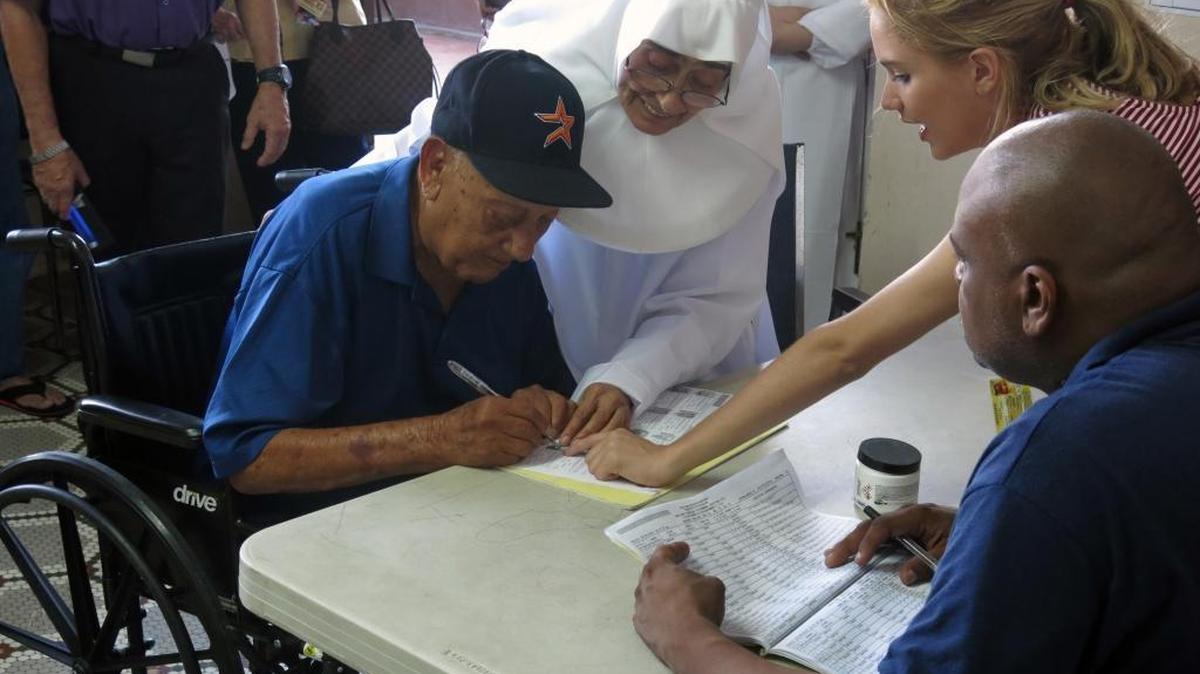 A voter signs in at a polling station to vote in the general election at an elementary school in San Juan, Puerto Rico, Tuesday, Nov. 8, 2016. Residents of Puerto Rico are U.S. citizens, but they can’t vote in the U.S. presidential election. The residents will vote June 11, 2017, on full U.S. statehood, but many say the timing couldn’t come at a worse time for the struggling island.