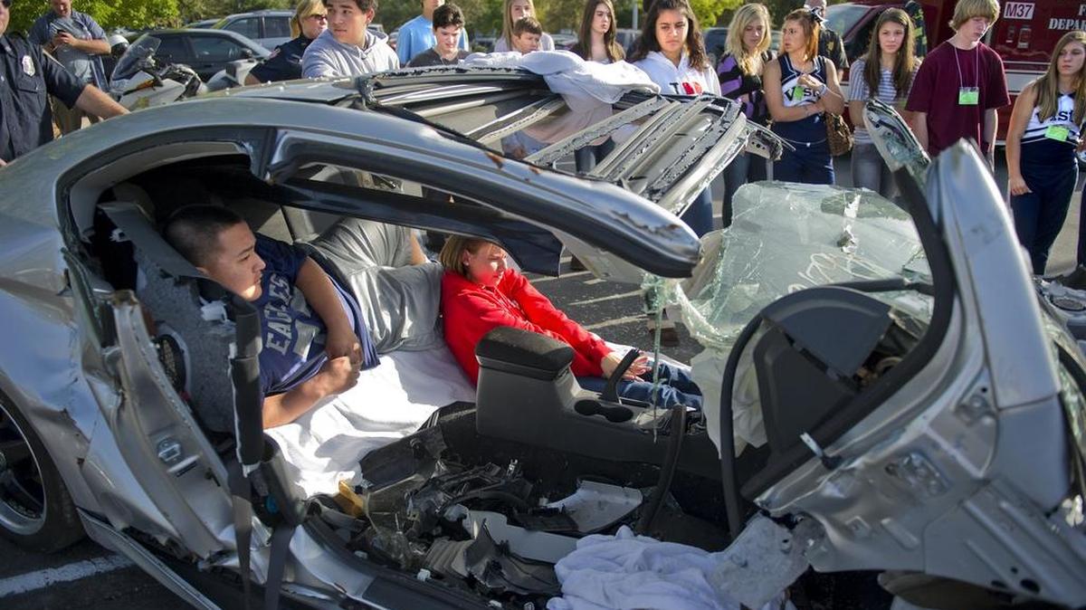 High school students help in a demonstration of a car accident during an event sponsored by P.A.R.T.Y., a program developed by an emergency nurse in Toronto, Ontario, in 1986, to teach youth the dangers and consequences of risky behavior.