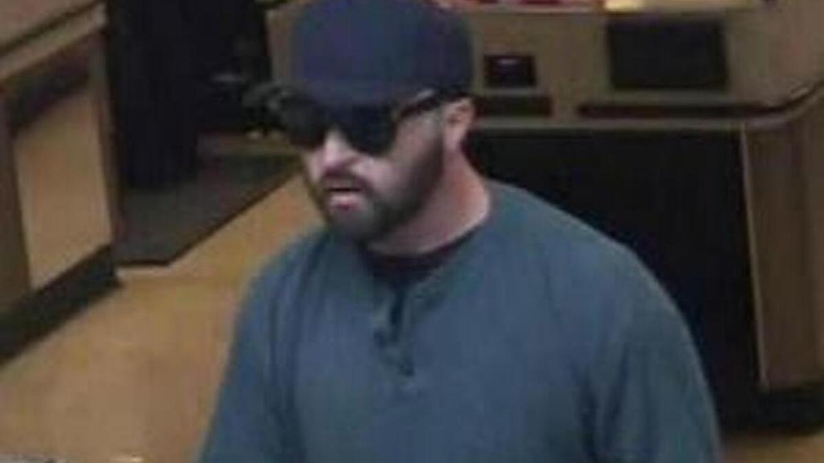 A surveillance photo shows a man dubbed the “Bearded Bandit,” who was sought by the FBI on suspicion of a series of bank robberies, including this one in Fremont, Calif., on Feb. 12. Authorities say a suspect in the case was arrested Thursday after being spotted buying razors to shave off his beard.
