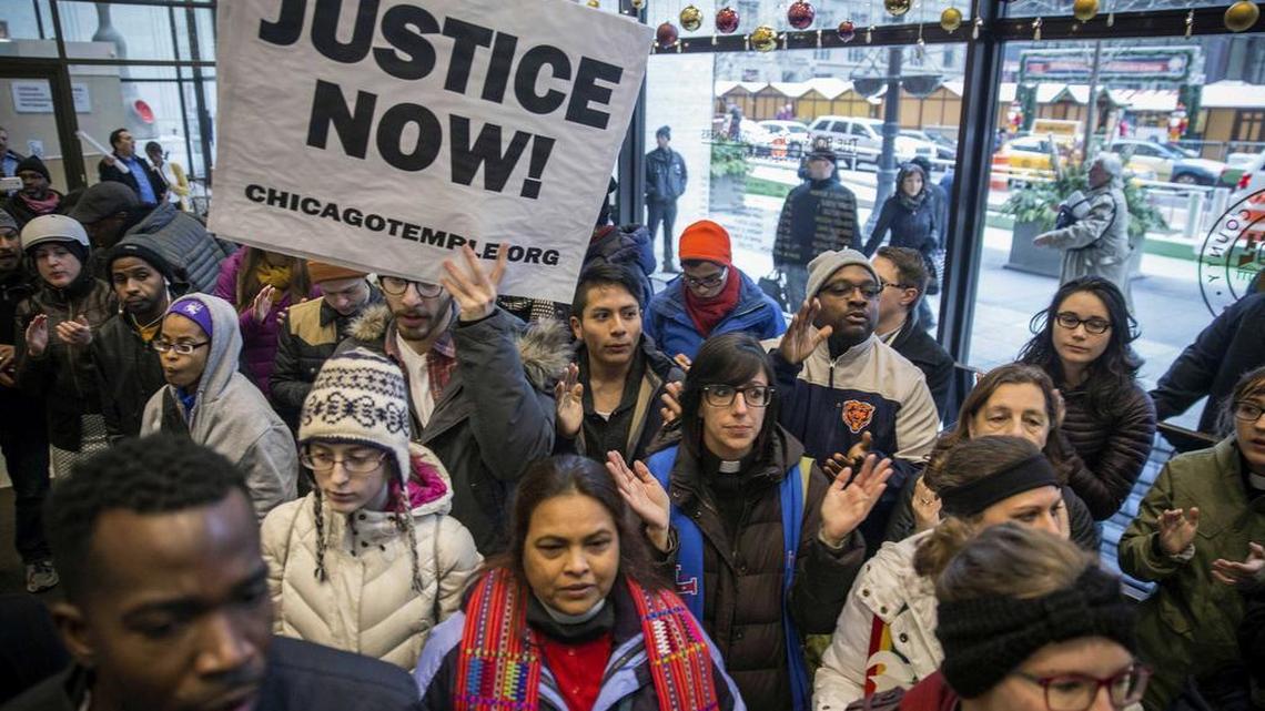 Clergy, labor leaders and supporters gather at the Cook County Administration Building Thursday in Chicago to demand the resignation of Cook County State’s Attorney Anita Alvarez before delivering 32,000 petition signatures calling for her to quit. The long wait to file charges against a white Chicago police officer who fatally shot a black teenager has provoked sharp criticism of the city’s top prosecutor.