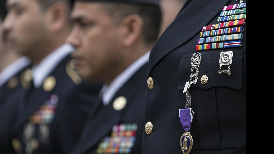 
A ceremonial Purple Heart is clipped to the chest of Sgt. Alonzo Lunsford, Jr., during a Purple Heart ceremony held at Fort Hood, Texas, on Friday, April 10, 2015. Survivors and family members of those killed during the attack by Maj. Nidal Hasan in the 2009 Fort Hood shooting were awarded 44 medals, Purple Heart for soldiers and Defense of Freedom Medals for civilians. The Army announced April 16, 2015, that the victims would also receive full medical and financial benefits. 



