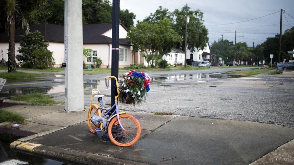 An old bicycle converted into an art project is tied to a streetlight in Palatka, Florida.
