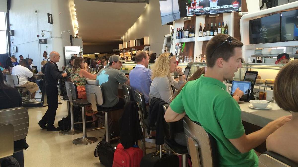 
All seats are taken at a food and drink bar taken at Ronald Reagan Washington National Airport after flights are delayed by technical issues on Saturday.
