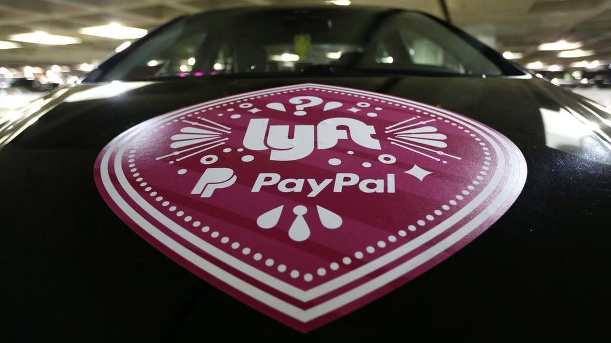 A vehicle with the logo from the Lyft ride sharing service is shown at Seattle-Tacoma International Airport, Thursday, March 31, 2016 in Seattle.