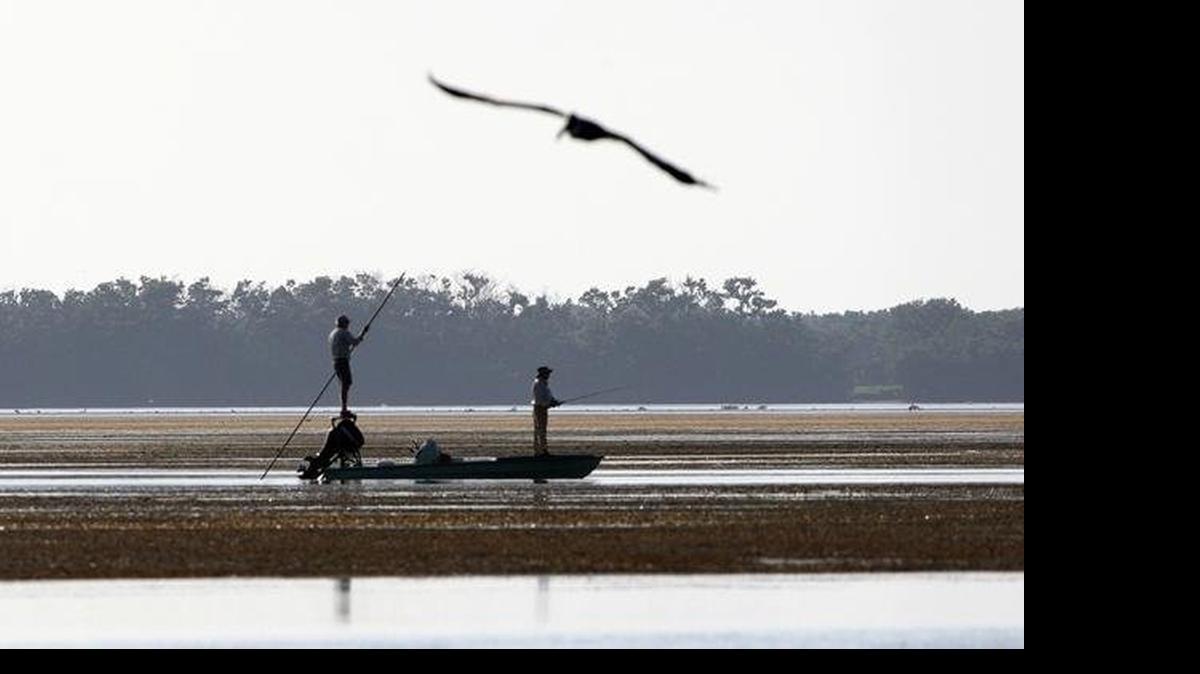 
A fisherman poles his boat in the shallows of snake bight in Florida Bay in Everglades National Park in 2007.
