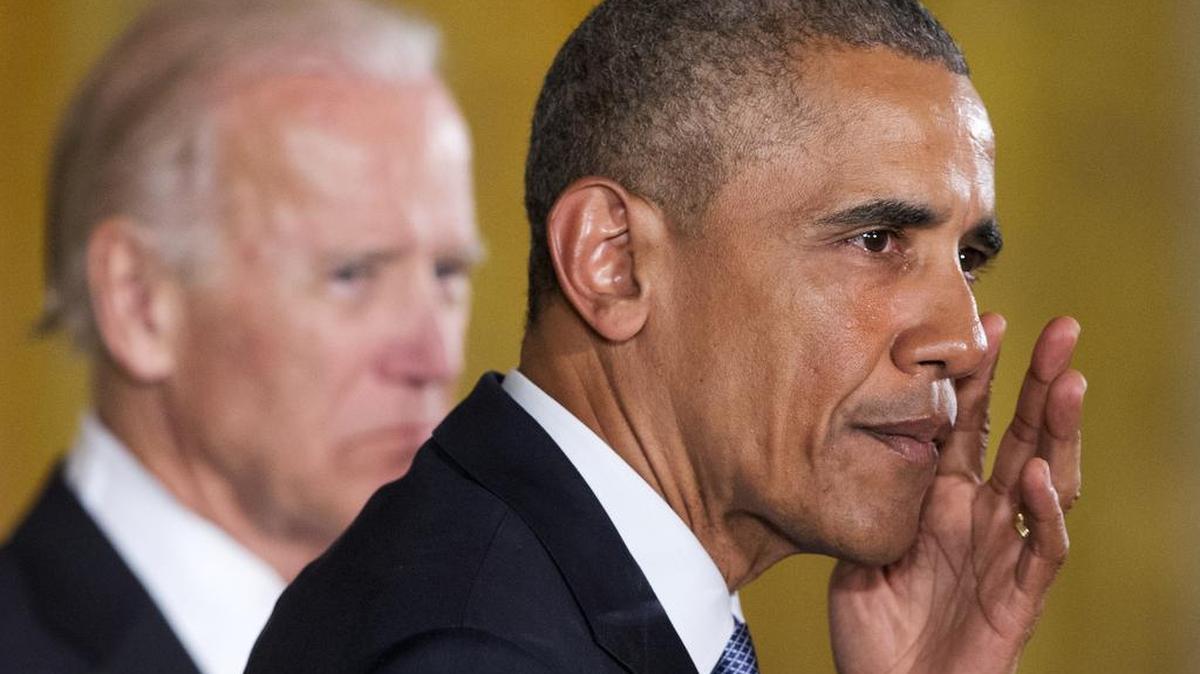 President Barack Obama, accompanied by Vice President Joe Biden, wipes away tears from his cheek as he recalled the 20 first-graders killed in 2012 at Sandy Hook Elementary School, while speaking in the East Room of the White House in Washington, Tuesday, Jan. 5, 2016, about steps his administration is taking to reduce gun violence.