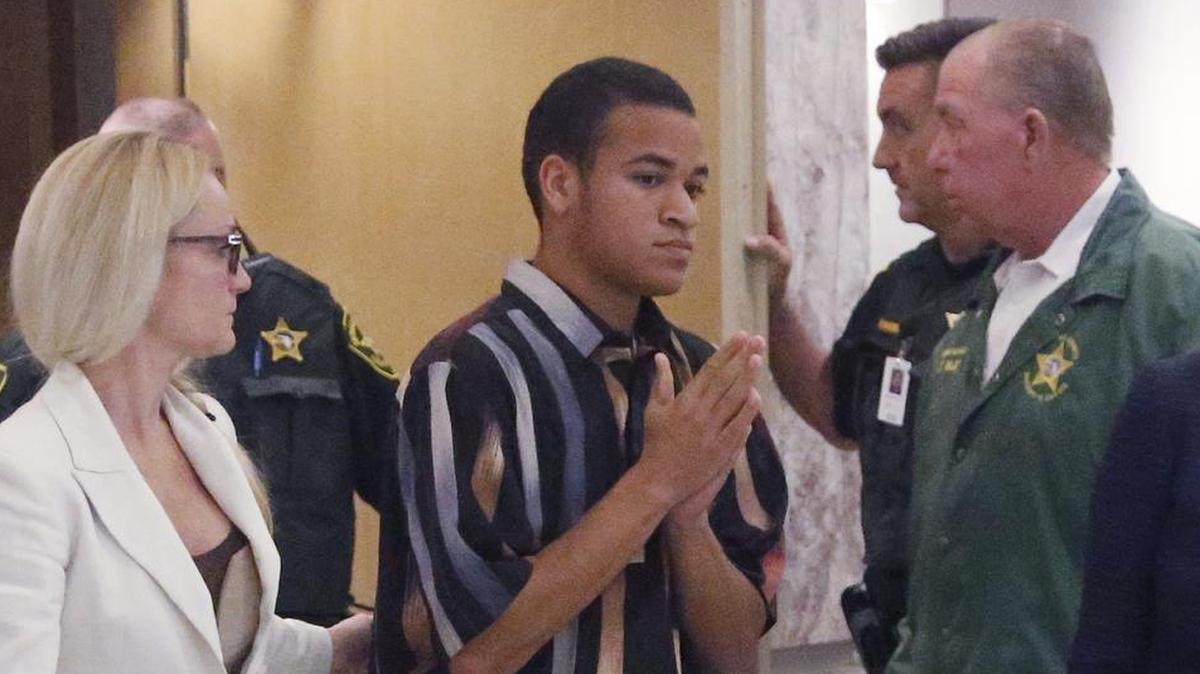 The brother of Nikolas Cruz, Zachary Cruz, center, leaves the courtroom after his brother's arraignment, March 14, 2018. The Broward Sheriff’s Office arrested Zachary Cruz March 19, and charged him with trespassing at Marjory Stoneman Douglas High School, the scene of last month’s mass shooting by his brother Nikolas.