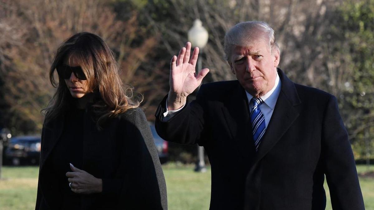President Donald Trump and first lady Melania Trump walk across the South Lawn upon arrival on Marine One at the White House in Washington, D.C., on Saturday following a trip to Florida.
